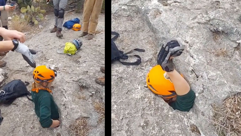 Σπηλαιολόγος περνάει μέσα από μια στενή είσοδο σπηλιάς