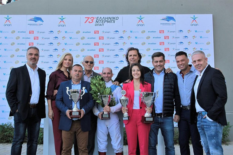 Ο Διευθυντής Πωλήσεων TASTY, Ηλίας Ξηντάρας με την Ευαγγελία Αραβανή, τους εκπροσώπους της προπονήτριας Ντίνο και Άννα Γεωργίου, το μέλος του Δ.Σ. της ΦΕΕ, Μάκη Σκρεπετό, τον αναβάτη Γιάννη Λαζαρίδη, τον πρώην διεθνή ποδοσφαιριστή Τάσο Μητρόπουλο, τον αναπληρωτή Διευθύνων Σύμβουλο ΟΠΑΠ, Οδυσσέα Χριστοφόρου, τον Κώστα Σόμμερ και τον Ιδιοκτήτη της ΔΟΥΣΗΣ COM Τάσο Δούση