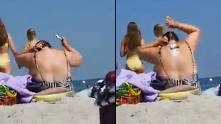 Γυναίκα βάζει αντηλιακό στην πλάτη της