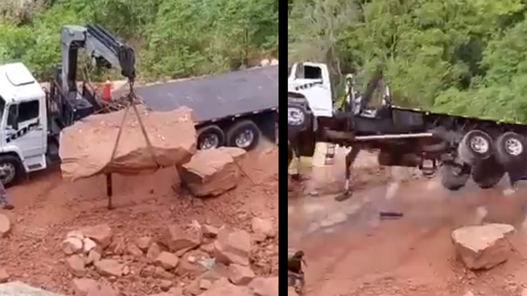 Χειριστής γερανού φορτώνει έναν βράχο σε φορτηγό 