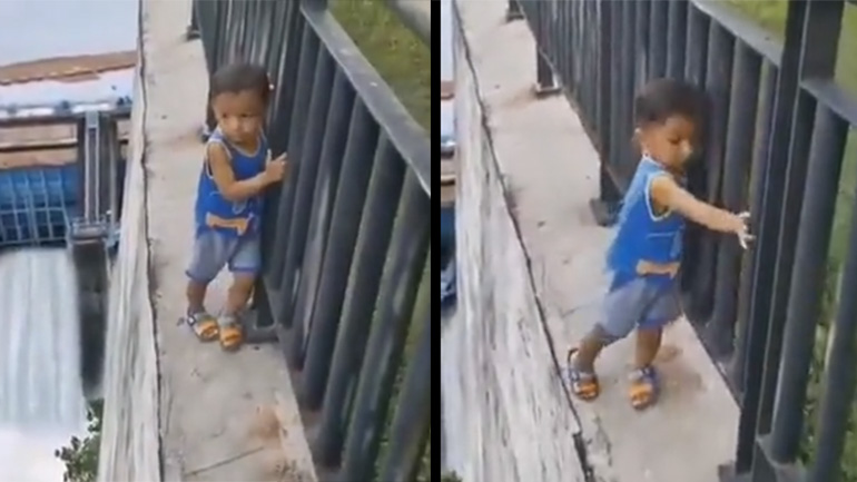 Ένα παιδί περπατά στην άκρη του τοίχου ενός φράγματος