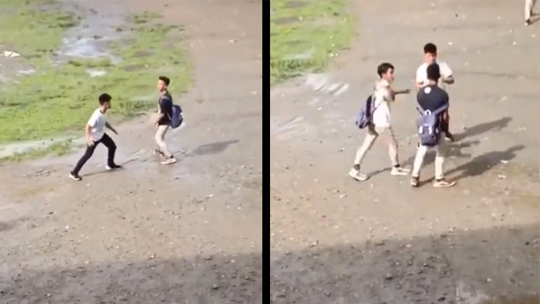 Παιδί ηρεμεί δύο μαθητές που θέλουν να τσακωθούν στο σχολείο
