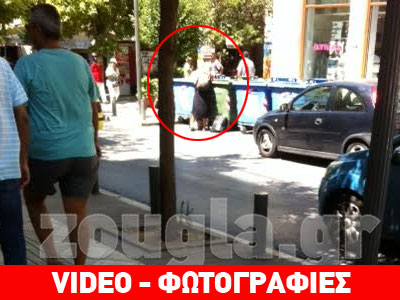 Γυναίκα ψάχνει τροφή στα σκουπίδια της Αθήνας