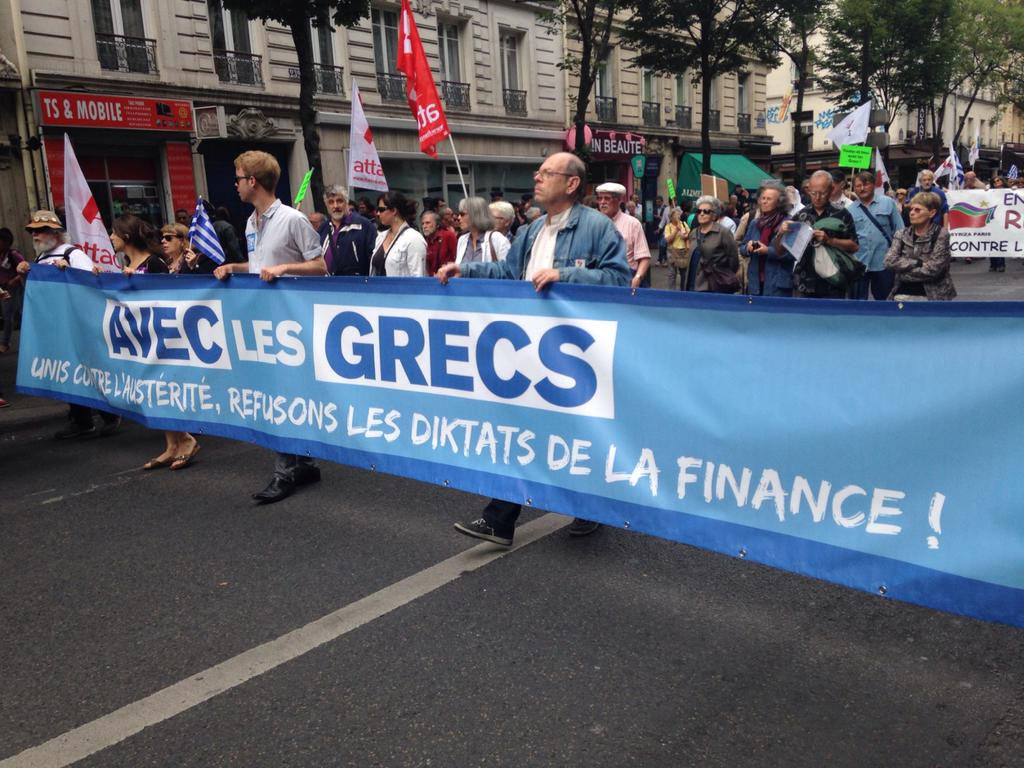 «ΜΑΖΙ ΜΕ ΤΟΥΣ ΕΛΛΗΝΕΣ, 'Ενωμένοι κατά της λιτότητας, αρνούμαστε τους δικτάτορες της οικονομίας» αναφέρει το πανό